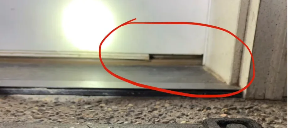Gap at the corner of a garage door where mice slip inside