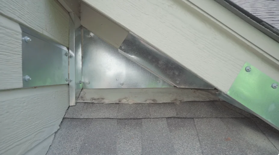 The same roofline junction sealed with metal flashing to stop roof rats